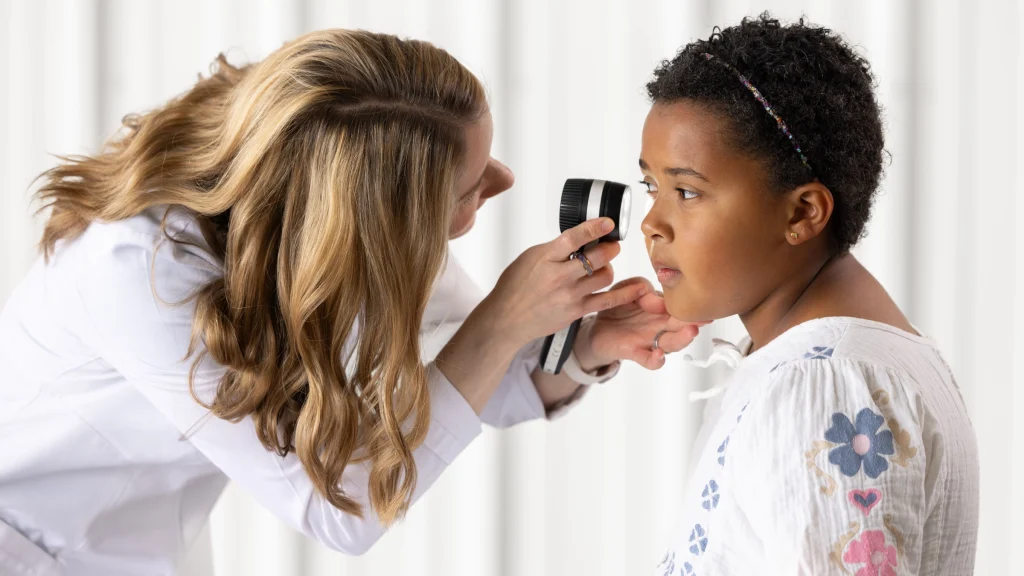 Dr Kappius examining a young patient's cheek